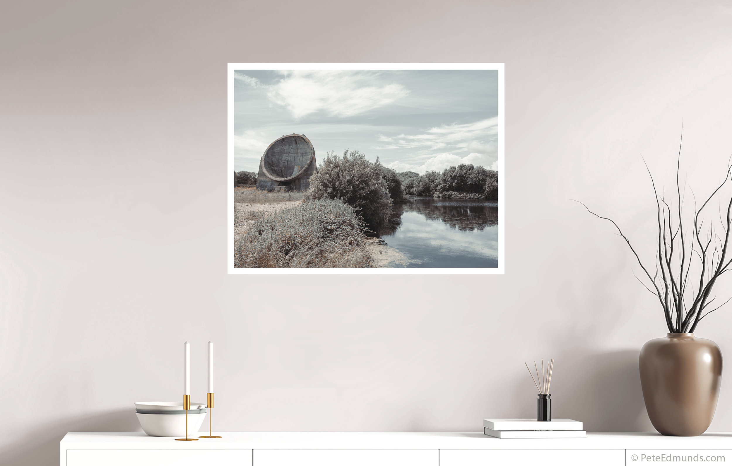 Fine art print Sound Mirror, Greatstone, UK by Pete Edmunds, 80 × 60 cm with 2 cm white border, shown above a white sideboard in a minimalist interior.