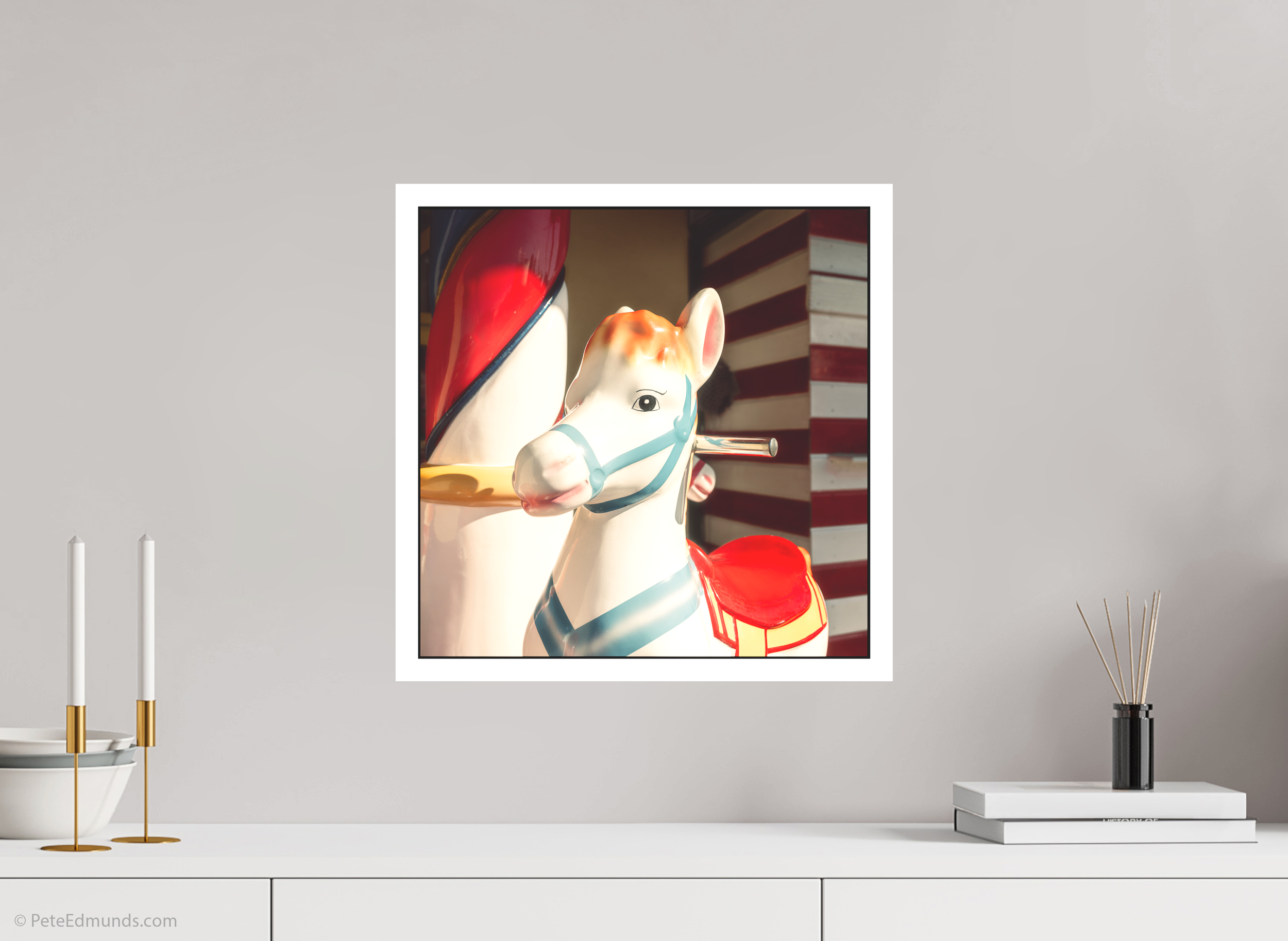 Fine art print Mini Carousel (Square) by Pete Edmunds, 40 × 40 cm with 2 cm white border, shown above a white sideboard in a modern interior.