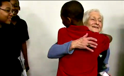 Students line up to hug Irene after a presentation. 