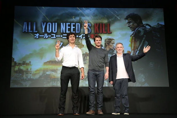 Director Doug Liman, far left, Tom Cruise, center, and producer Erwin Stoff wave during a press conference for their latest film " Edge of Tomorrow"  (AP Photo)