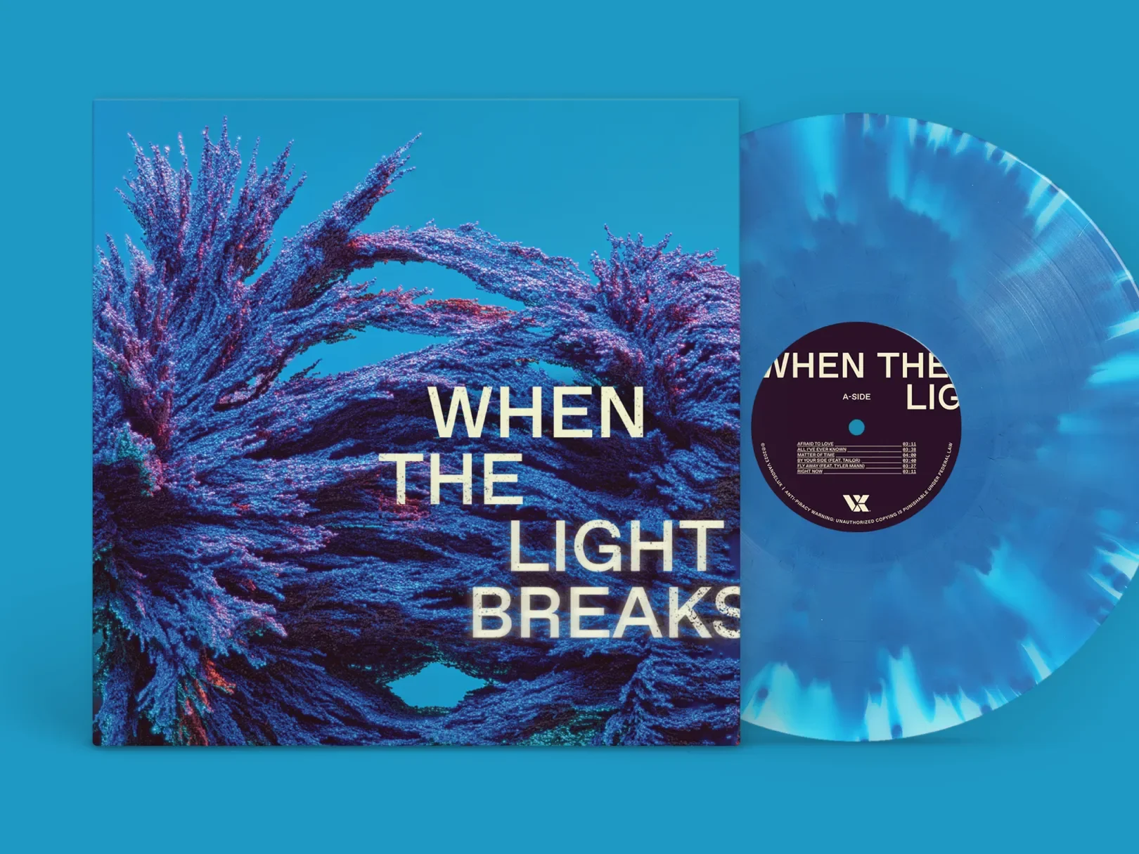 Blue vinyl record with a black center label next to its album cover featuring a stylized image of a wave and the title 'When the Light Breaks' in white text.