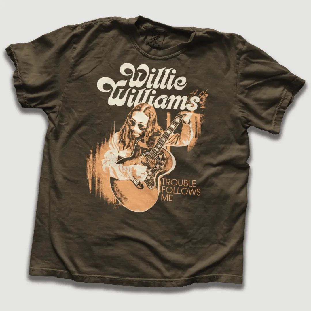 T-shirt featuring Willie Williams graphic artwork.
