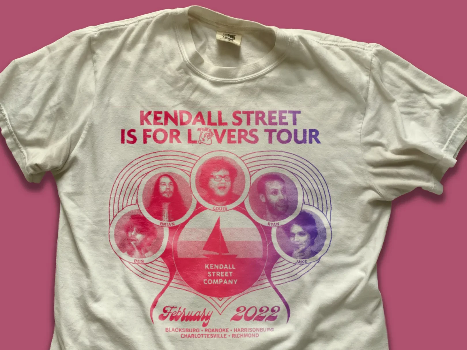 A white t-shirt with pink, purple, and red text and images promoting the Kendall Street Is for Lovers Tour in February 2022, featuring photos of five band members, the band's logo, and tour locations.