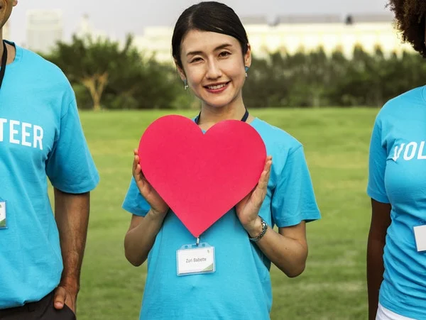 Woman holding a red heart cutout.jpeg
