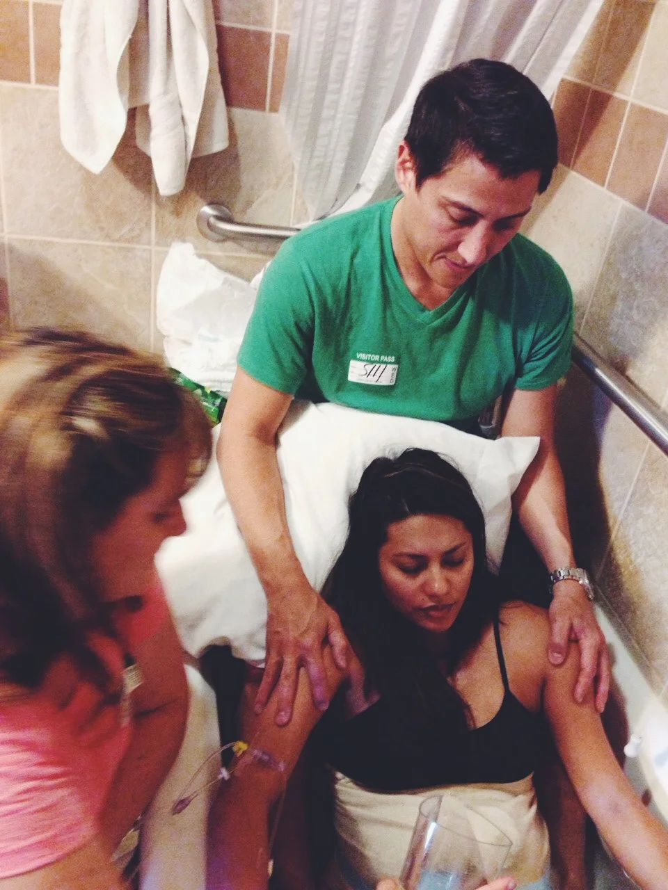 My doula Laura and my husband Sal coaching me through my contractions in the tub. 