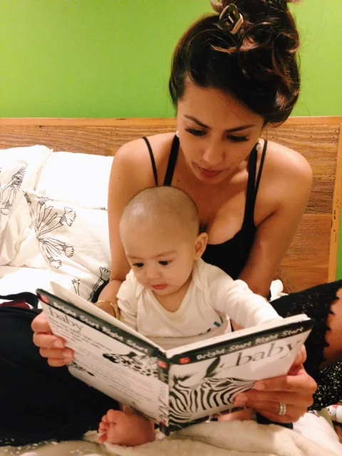 Checking out one of the many books we picked up for him from Powell's. 