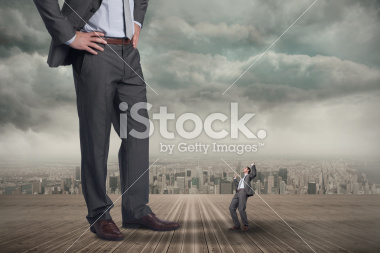 stock-photo-41830966-composite-image-of-businessman-posing-with-hands-up-and-giant.jpg