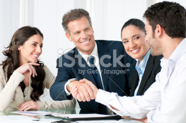 stock-photo-15195325-businessmen-shaking-hands-as-colleagues-smile.jpg
