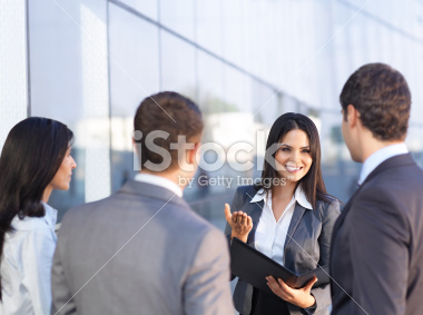 stock-photo-18307915-young-business-woman-talking-with-colleagues.jpg