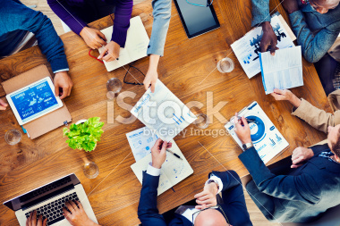 stock-photo-41876160-papers-are-passed-in-a-business-meeting.jpg
