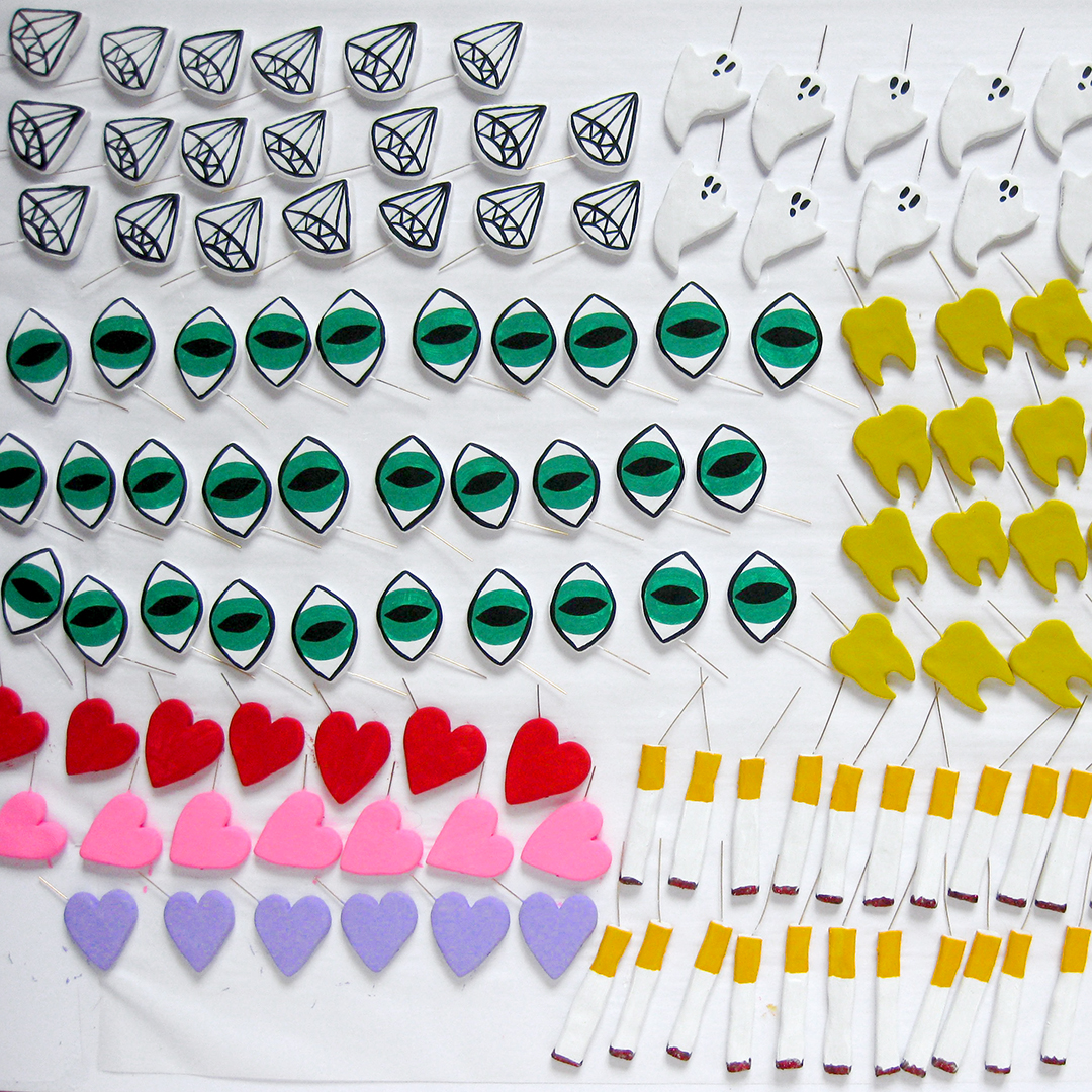 Painted charms are matte before they are varnished, dusted with glitter, and coated in resin. This is my favorite stage.