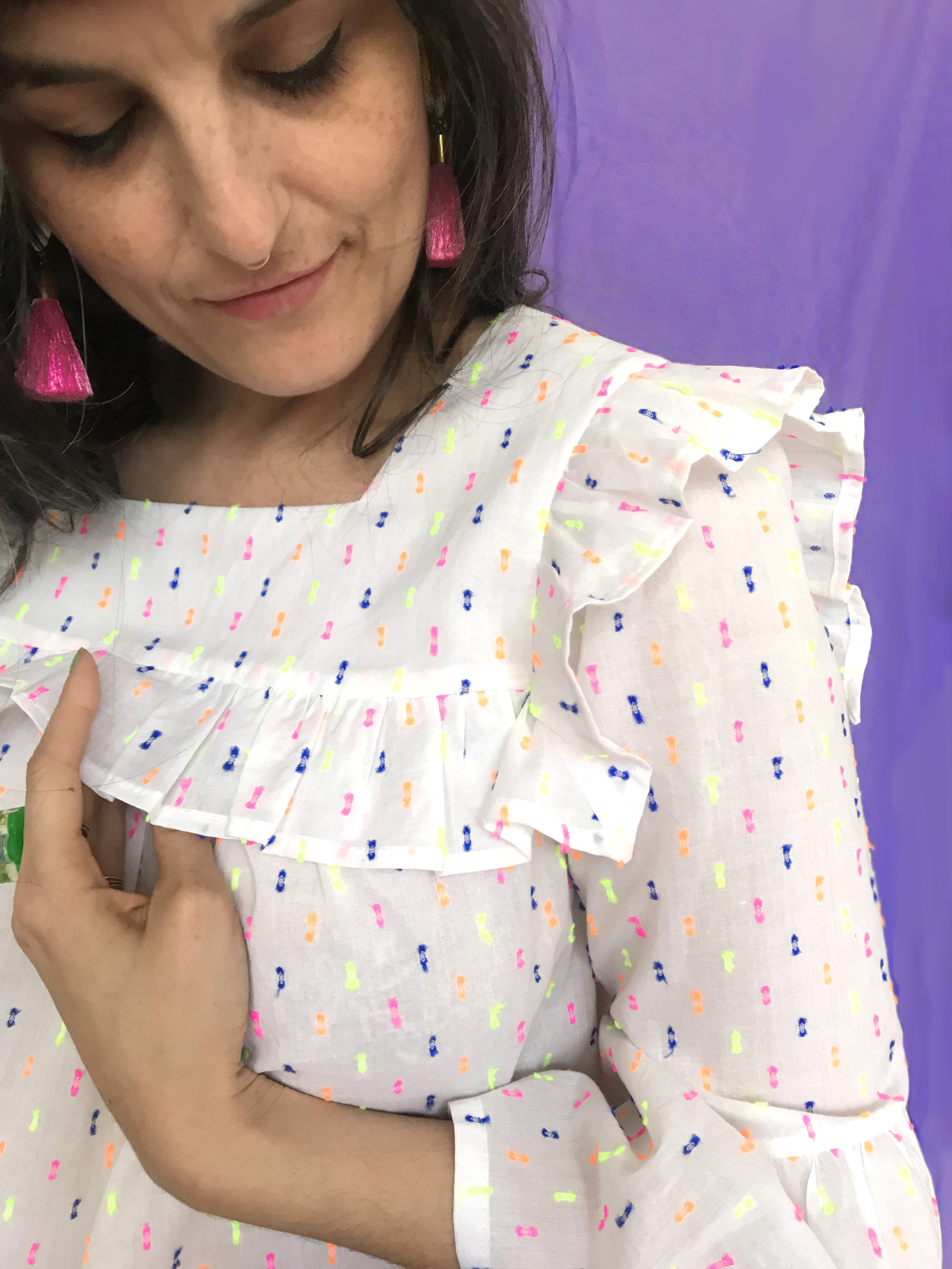 The ruffles are sandwiched between the yoke and yoke lining. This pattern has lots of markings to help you get crisp points to the yoke corners.