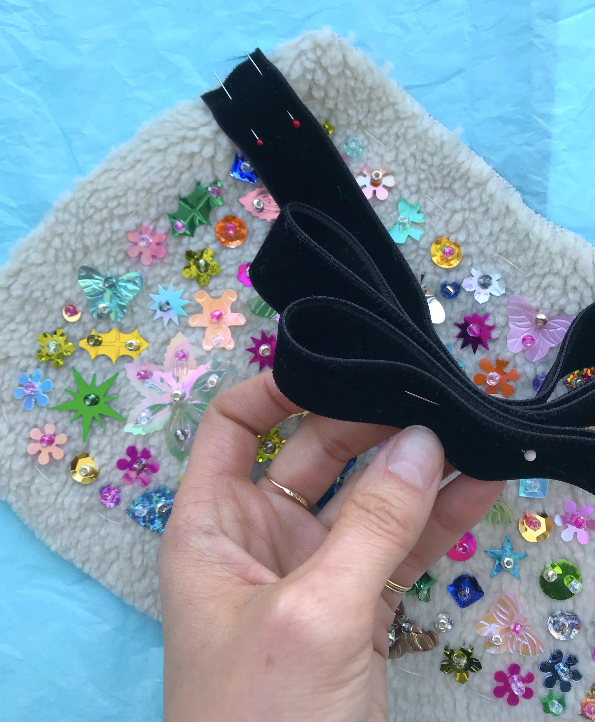 Place your ribbons in the front corners of your collar - you can try it on at this point, but remember, there is a lot of seam allowance preventing it from fitting perfectly. Once you like the ribbon placement, baste them in place, and pin up the ex