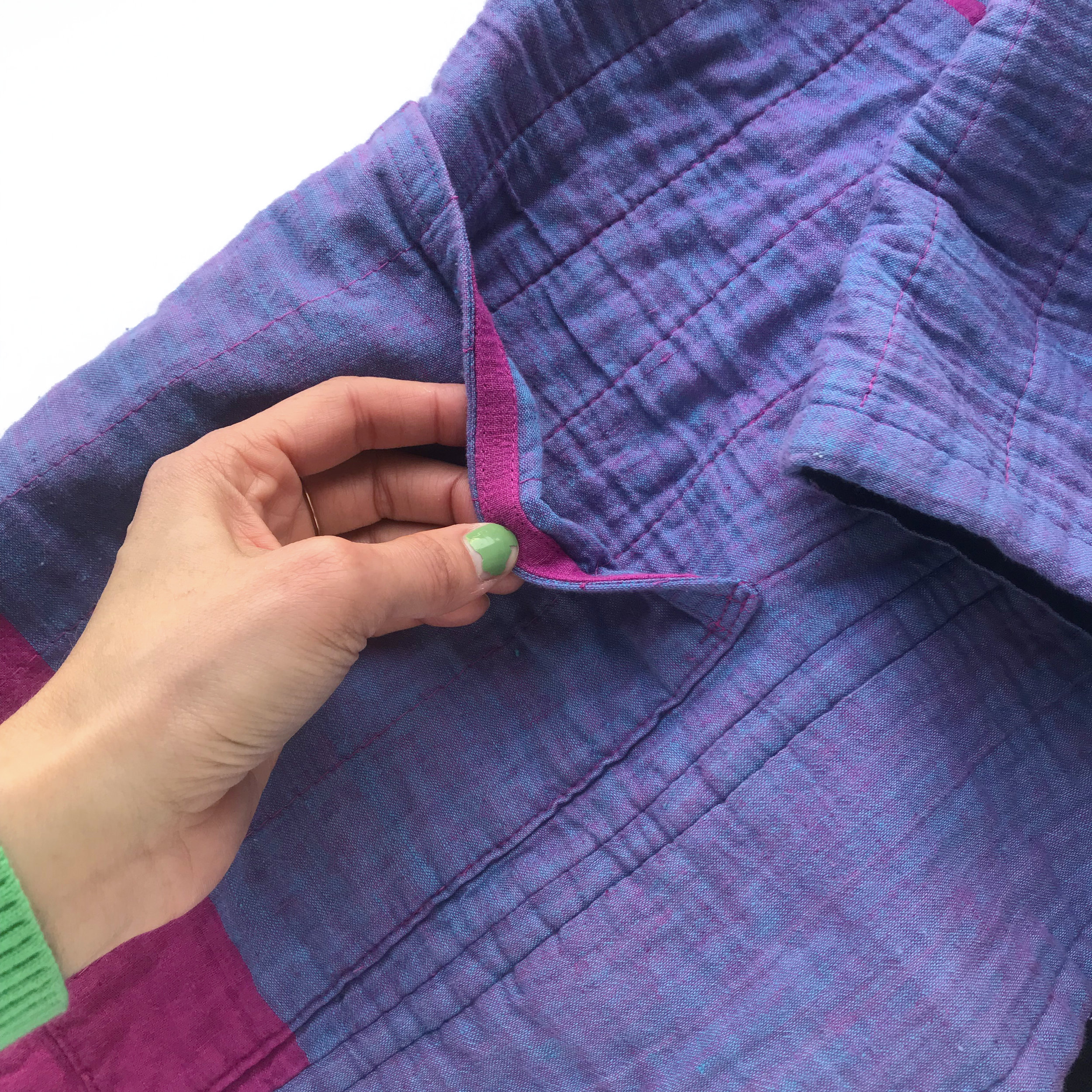  Here you can see how I reinforced the top edge of the pocket. I wrapped stable twill tape in self fabric and edge stitched both edges along the top of the pocket. 
