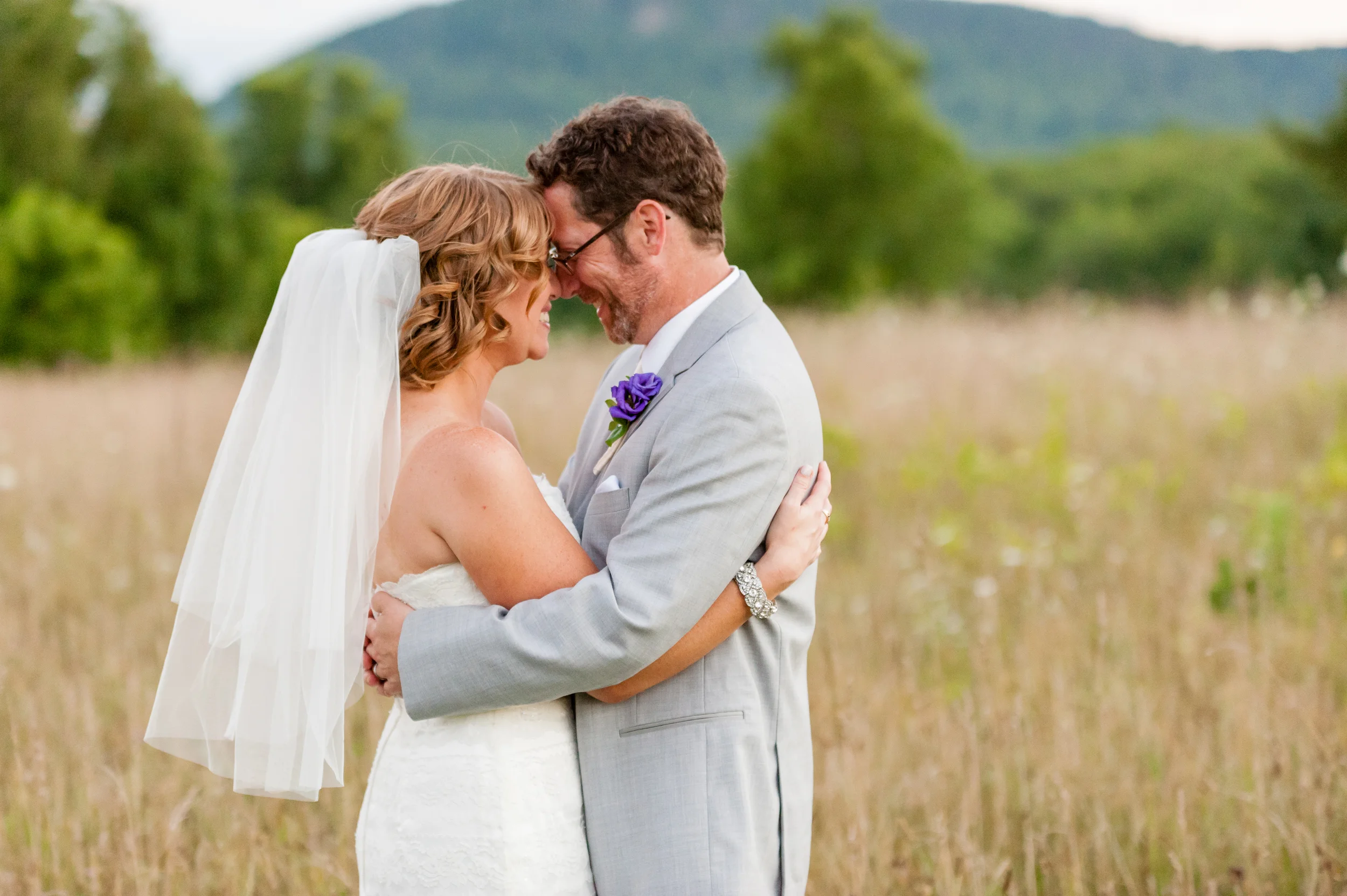 Bride and Groom in field at The Red Barn at Hampshire College in Amherst, MA
