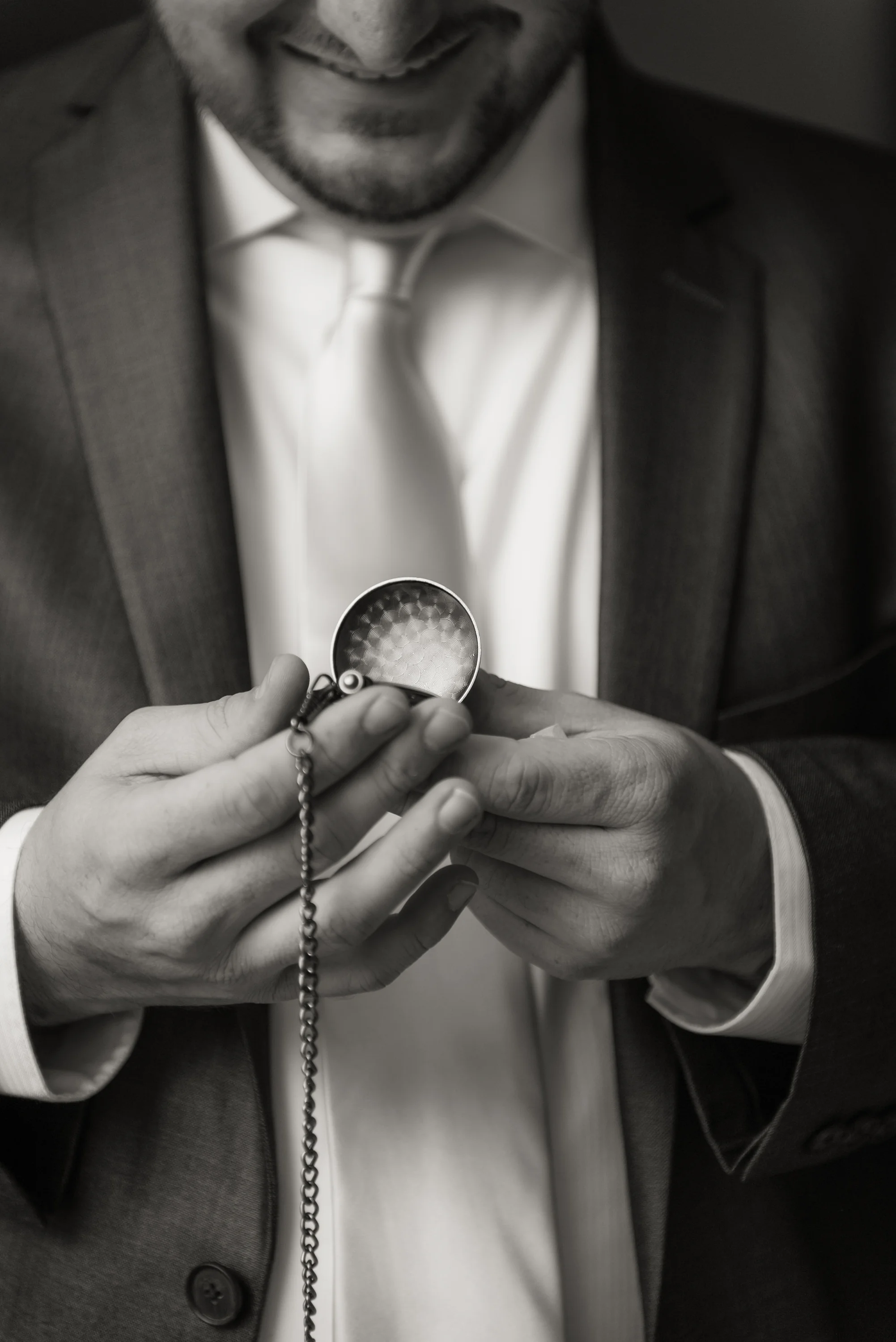 Groom getting ready with gift from bride