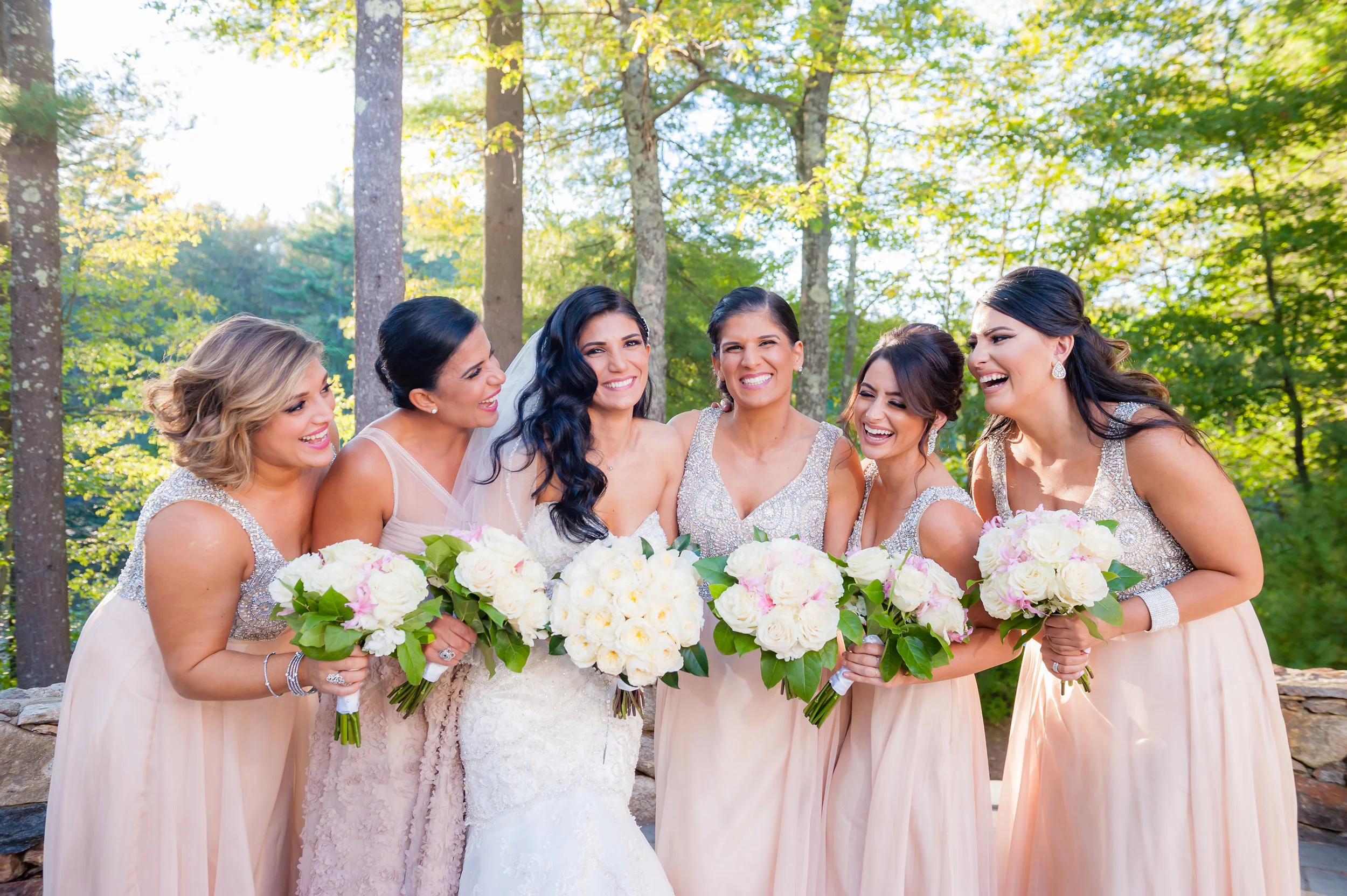 bride with bridesmaids wearing blush pink dresses and ivory bouquets, photographed by Mike Sears Photography