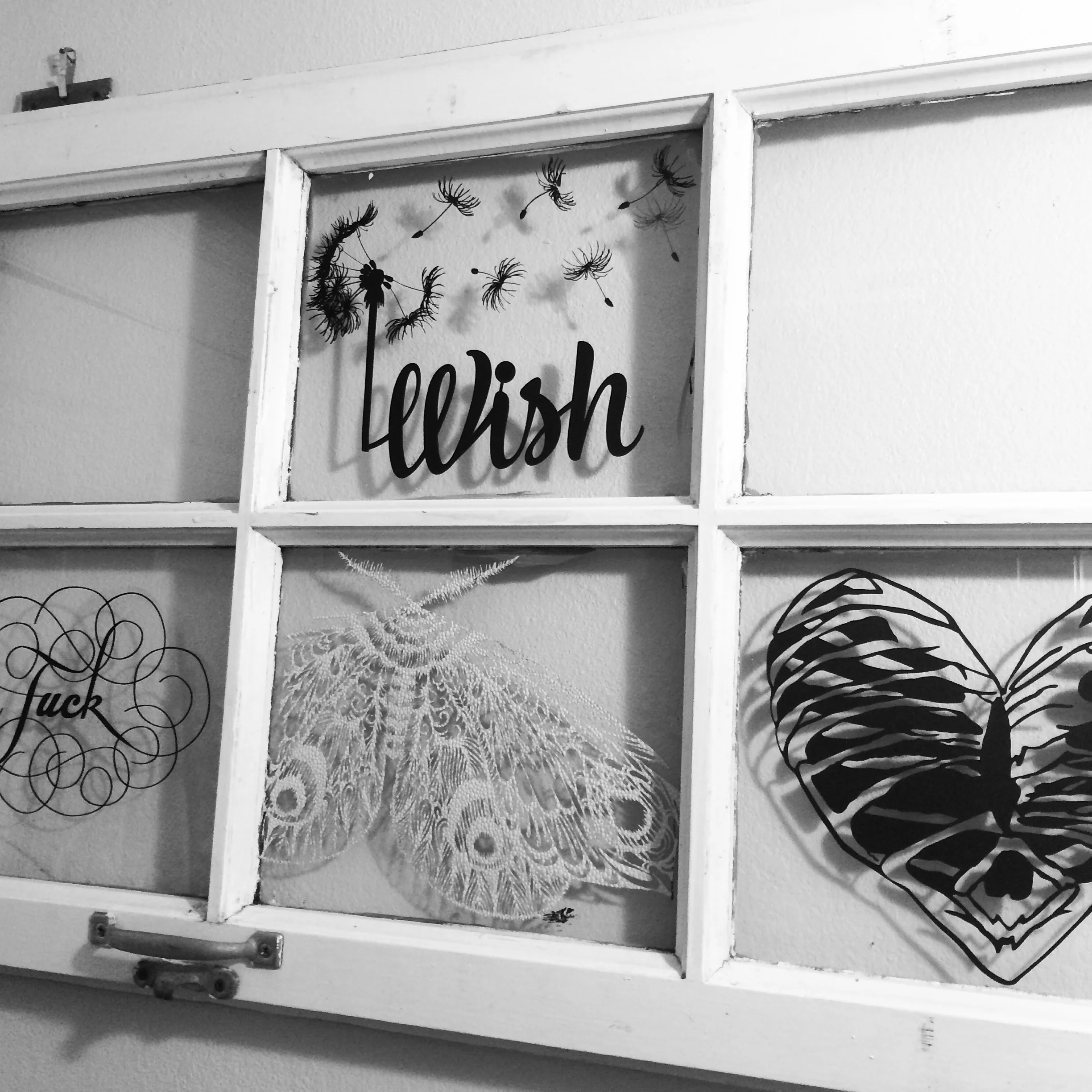 Filling up my street-find window with laser cut paper creations. 