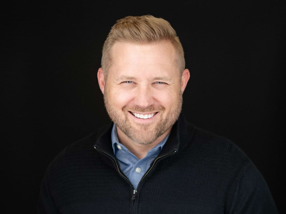 Headshot of blonde man on black background in photography studio Miranda Kelton Photography