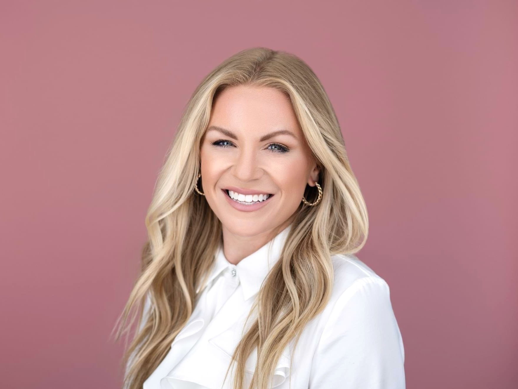 Headshot of Blonde Woman on Pink Background in a Photography Studio by Miranda Kelton Photography
