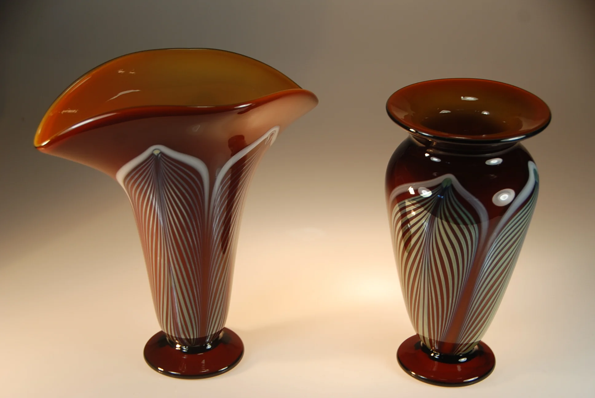 A couple of Honey Amber vases with the hand decorated "feather Pattern" going out for gifts. circa 2014 On the left is a "Fan" vase and the right is a "high shoulder" vase signed and dated by rick strini
