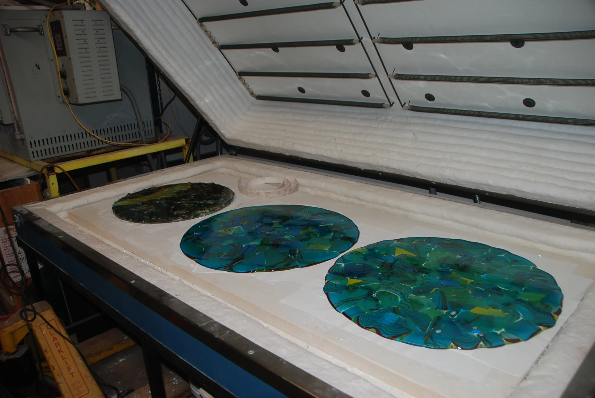 shown here are three fusedpieces that will become a SINK, far left, and two shallow plates or bowls. Now that I have finished a big production order blowing glass, I am catching up with the fusing. more to follow