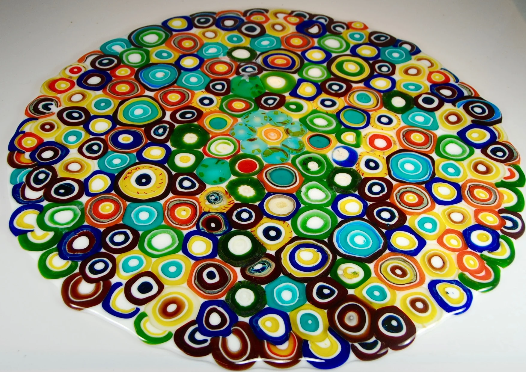 Blown elements cut and fused , then slumped into a dome for a entryway up light. 24" diameter about 65 piece per sq.ft. stay tuned for the finished piece. artist rick strini 2015-16 named after the Opihi shells at the waters edge. 