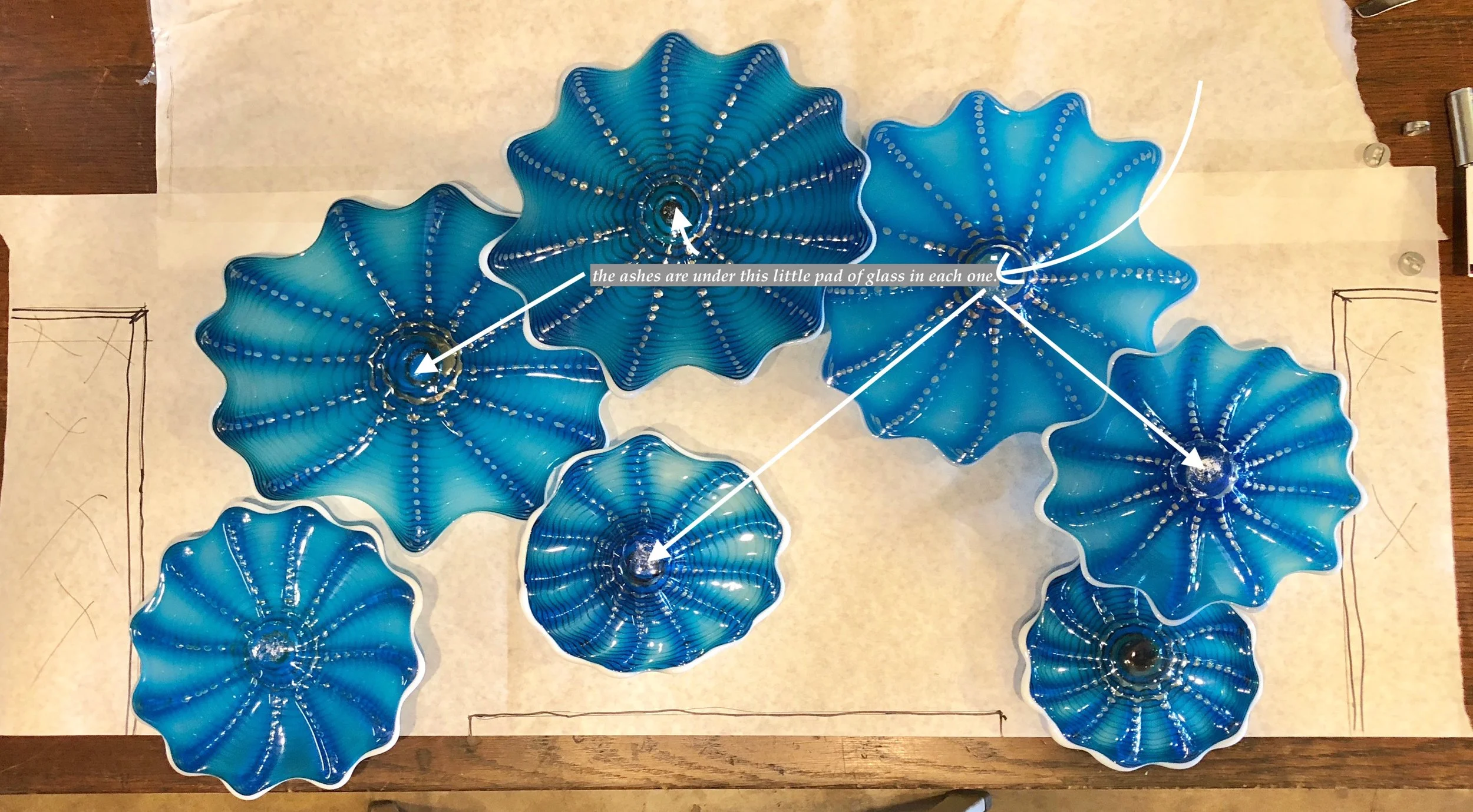 Memorial Rondel Wall splash where the ashes of your loved one are placed in the center and a small delicate pad of glass is placed over it trapping it forever in the glass. Each rondel is done the similar fashion and then grouped in a cohesive artful display . rick Strini 