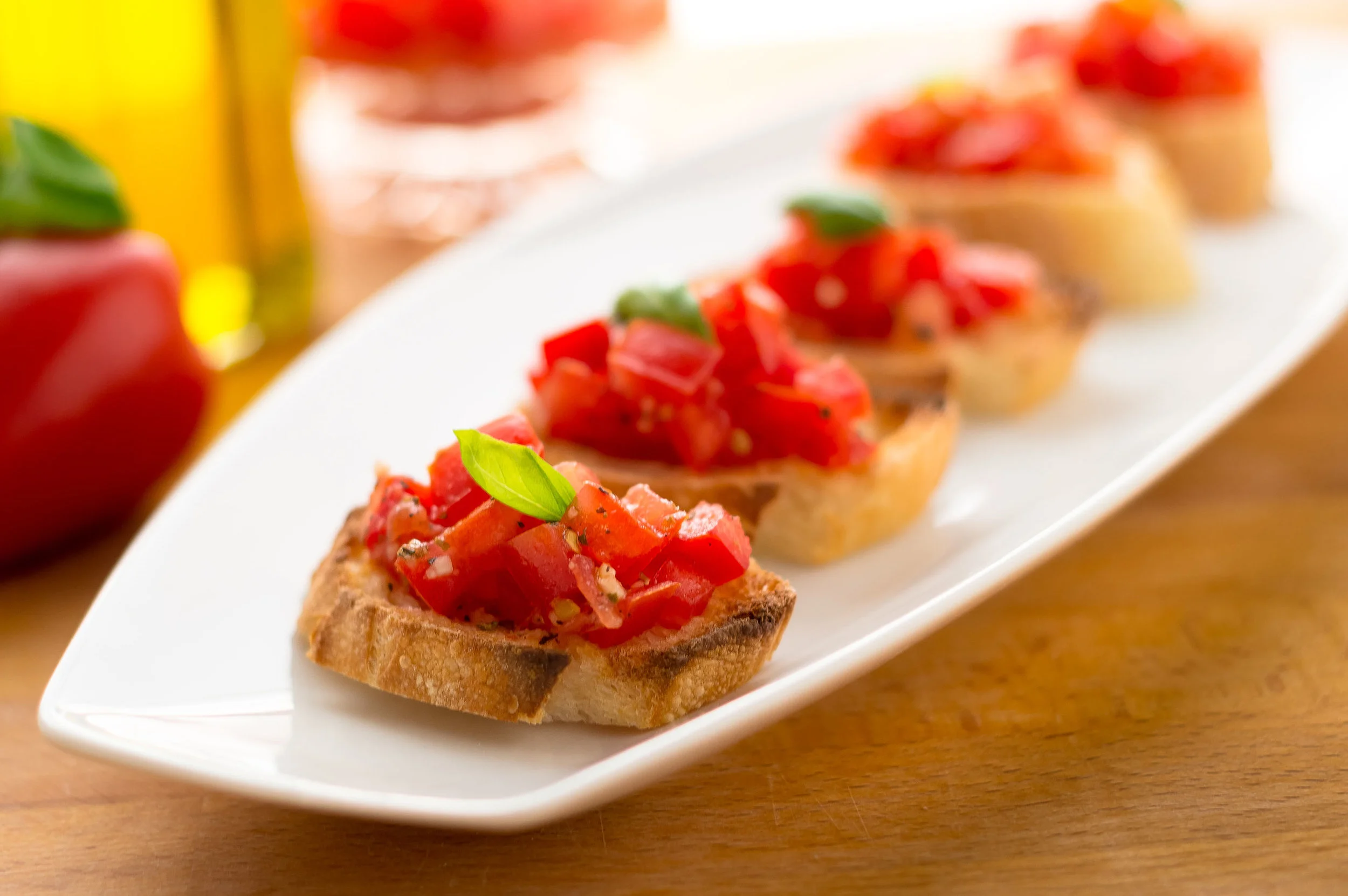 Plate of Bruschetta. Italian tomato bruschetta served as appetizer, made with fresh ingredients like tomatoes, garlic, basil, bread and olive oil..jpg