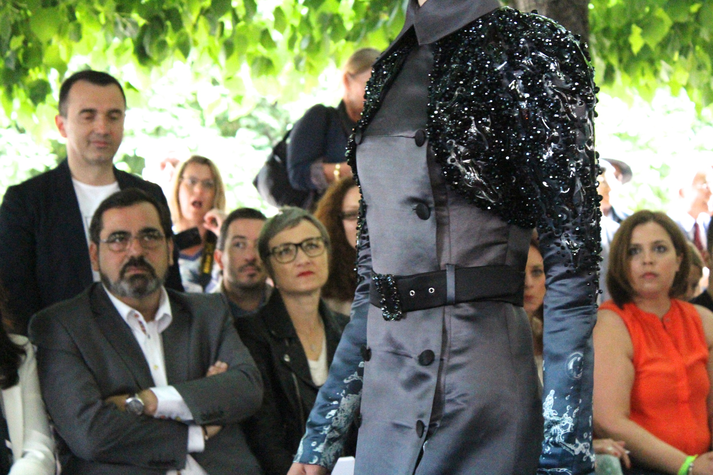 Shimmery details on the shoulders of the coat and the belt buckle