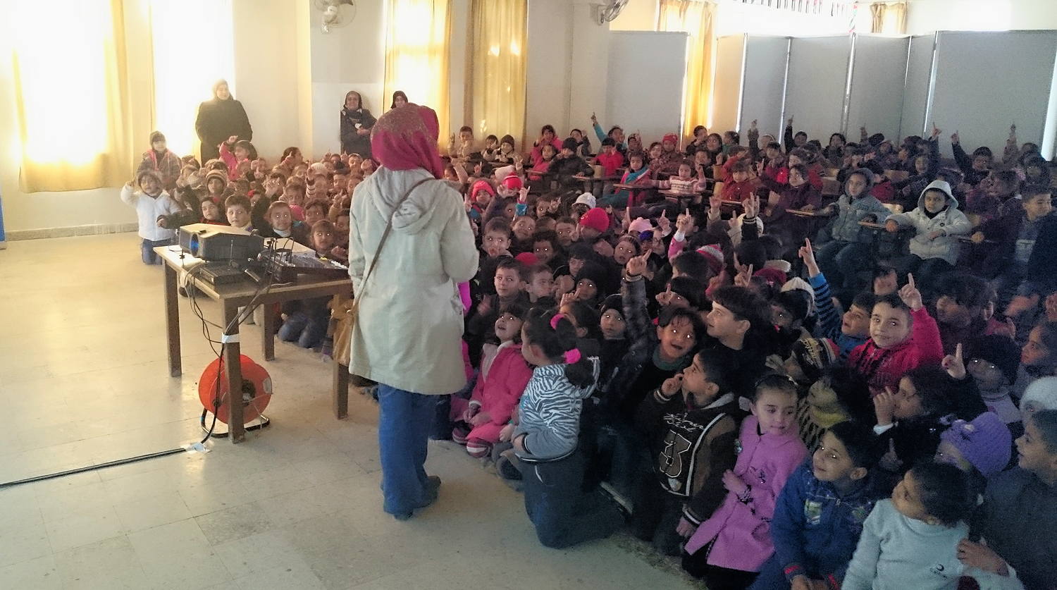 Children take part in a discussion after educational screening, March 2015 