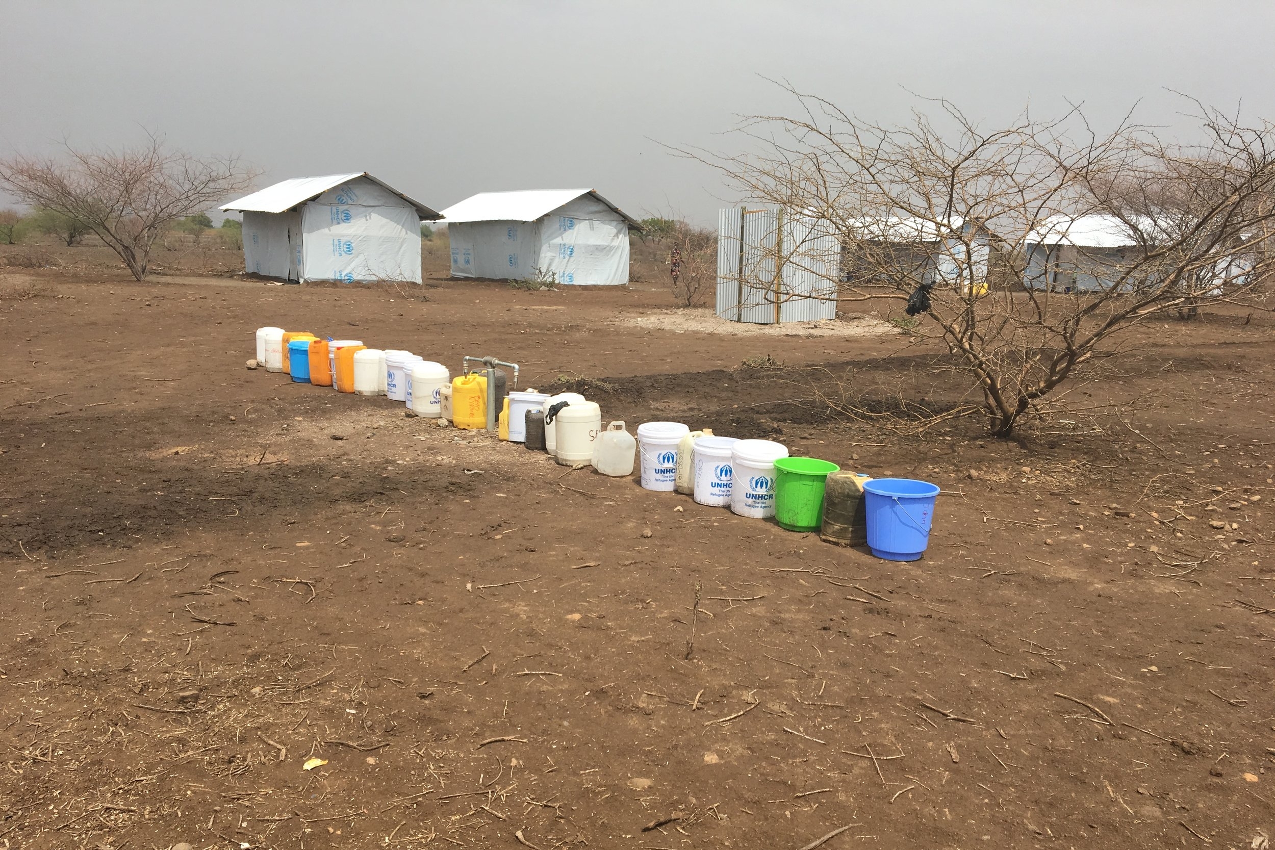 Jerry cans queued at water tap in Kalobeyei ©FilmAid/OCallaghan