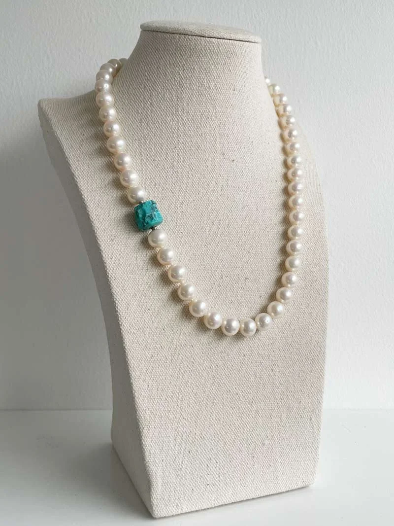 9mm cream freshwater pearl strand with small interchangeable rough turquoise nugget clasp worn off centre