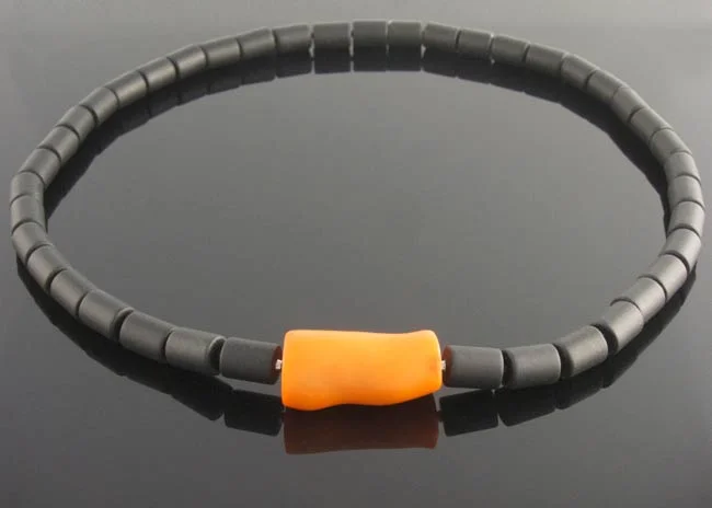 Matte black onyx cylinder necklet with interchangeable orange bamboo coral clasp