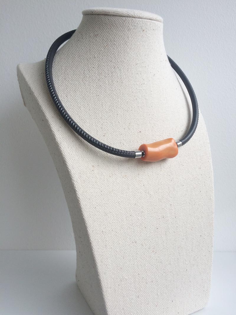 Grey leather necklace with orange bamboo coral feature clasp