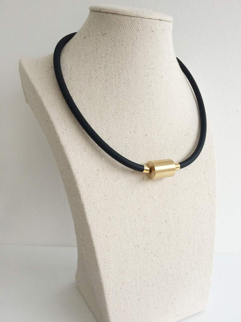 Black rubber with large gold cylinder clasp