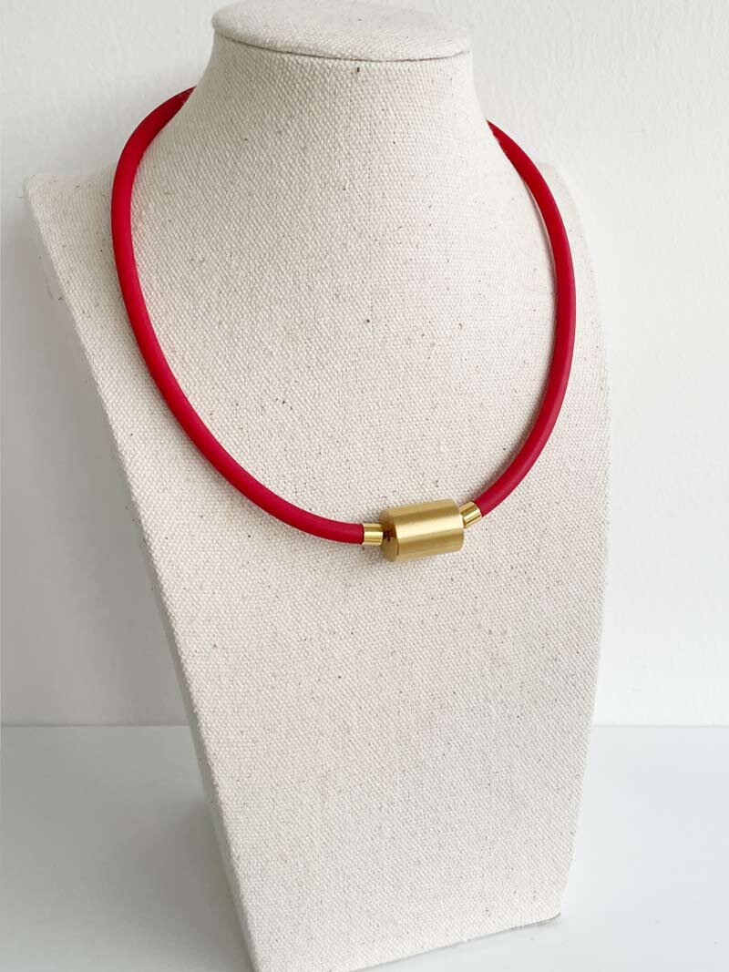 Red rubber with gold cylinder clasp