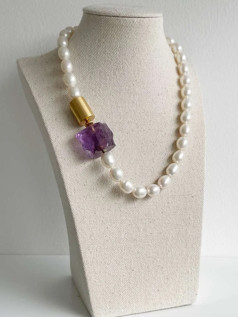 Hand knotted oval cream pearl strand with gold cylinder clasp and amethyst clasp connected by a small gold adaptor | Clasped