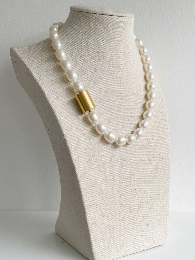 11-12mm oval freshwater cream pearl necklace strung with knots and closed with an interchangeable gold cylinder clasp | Clasped