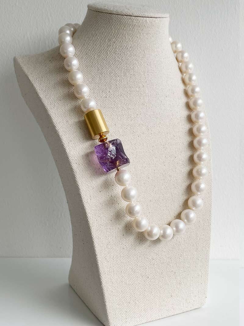 11-12mm round cream pearl with gold cylinder and amethyst nugget clasps in series