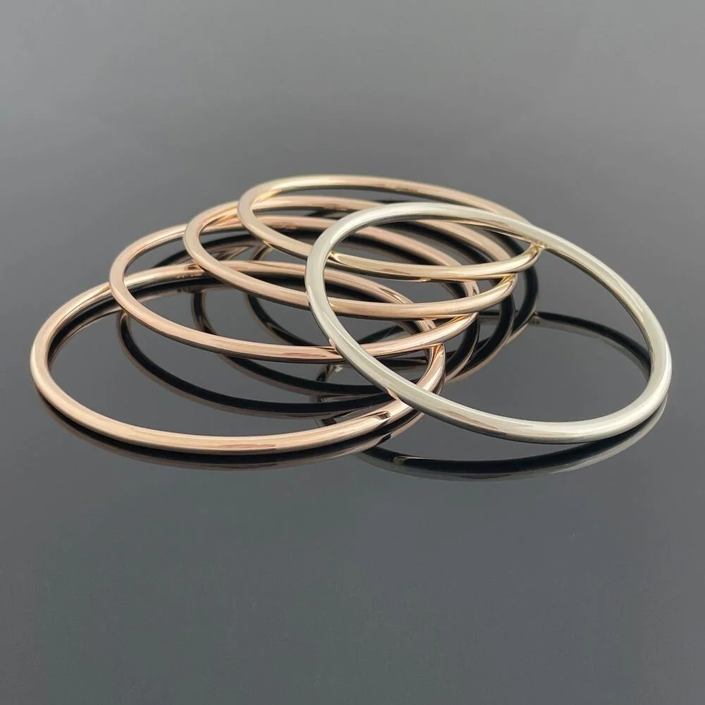 A clutch of recycled gold bangles in yellow and white made from a lifetime of gifted pieces. Three of the gold bangles were in turn gifted to my client's three daughters. The balance a gorgeous stack for mum to wear every day.⁠
⁠
If you have a some o