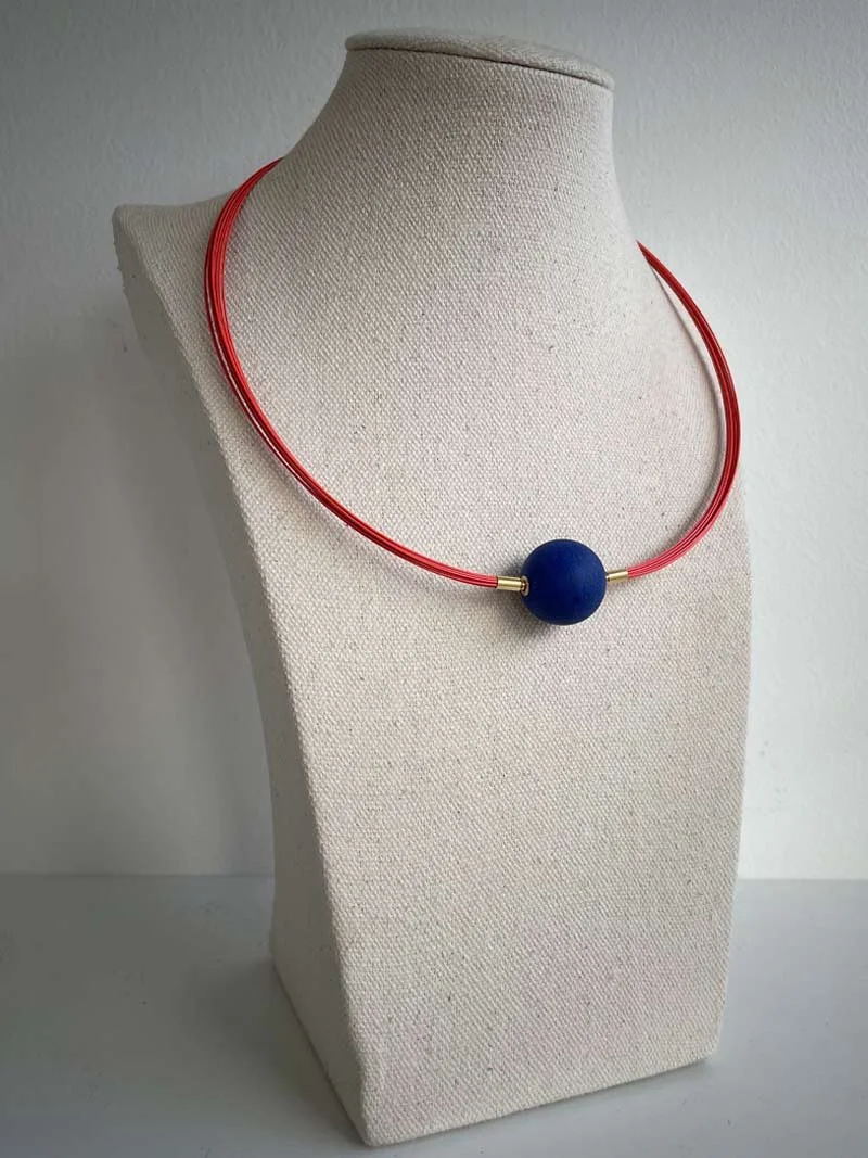 Orange multistrand necklace with interchangeable matte lapis feature clasp - part of Clasped's interchangeable necklace system