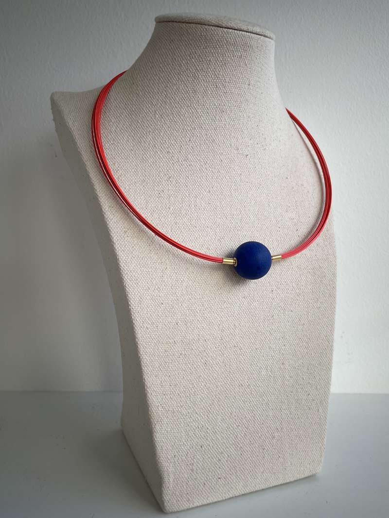 Orange coated steel multistrand necklace with interchangeable matte lapis feature clasp - part of Clasped's interchangeable necklace system