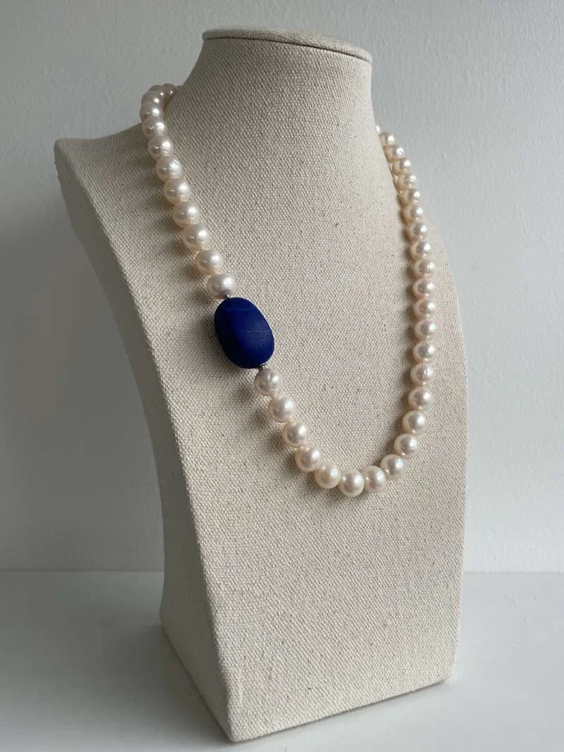 9.5-10mm freshwater cream pearl necklace with matte ovoid lapis lazuli feature clasp - part of Clasped's interchangeable necklace system