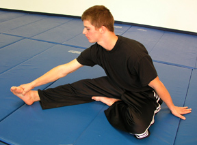 Exercise #5: Reach for your extended foot with the goal of touching your chest to your knee.