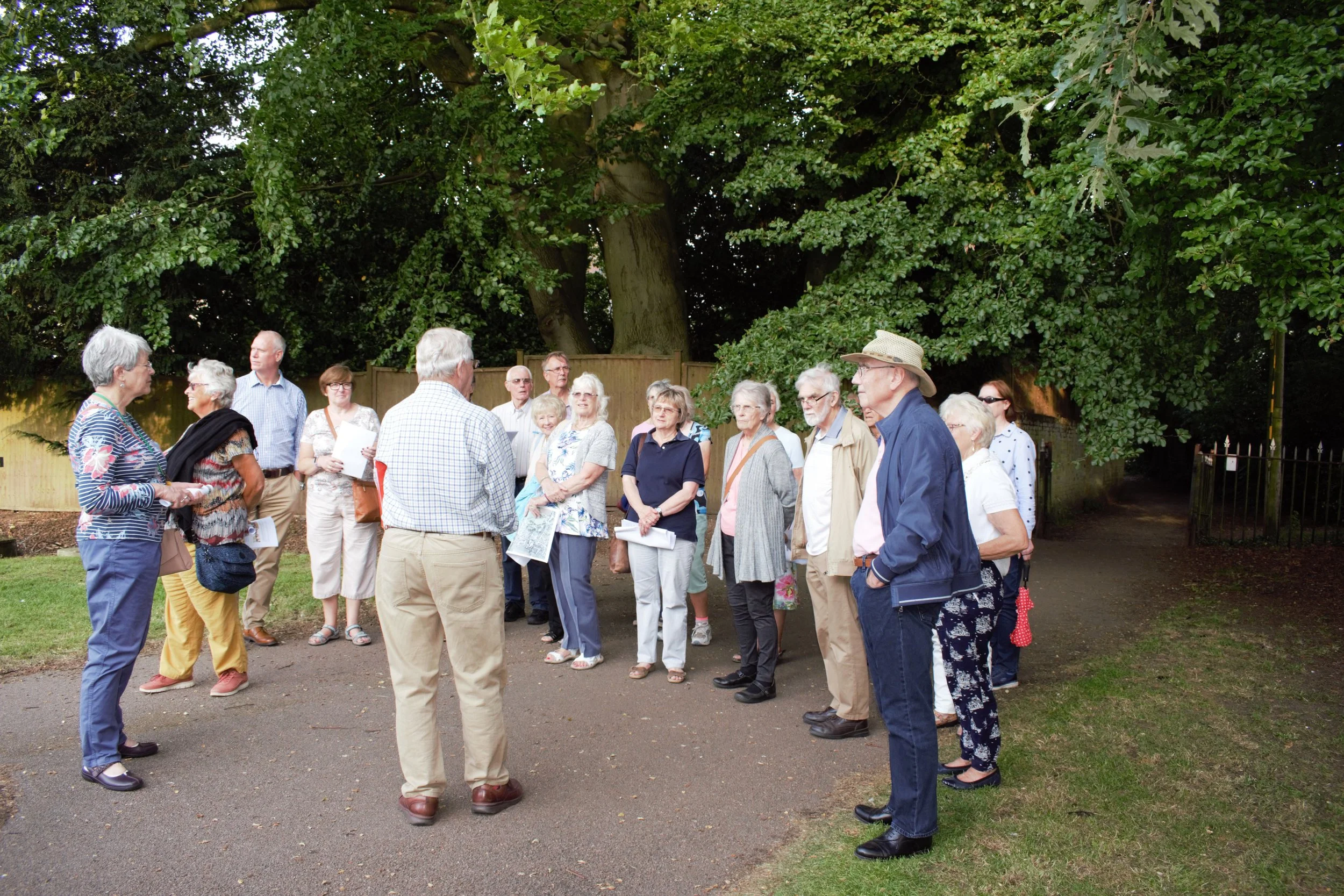 Dick Paden from the Balsham Map Group with our visitors in the churchyard, Balsham