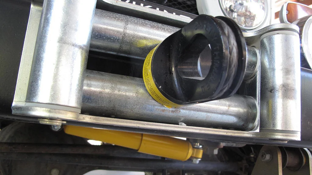 Roller fairleads work perfectly with synthetic winch lines, as long as they're not burred from prior use with steel cable.