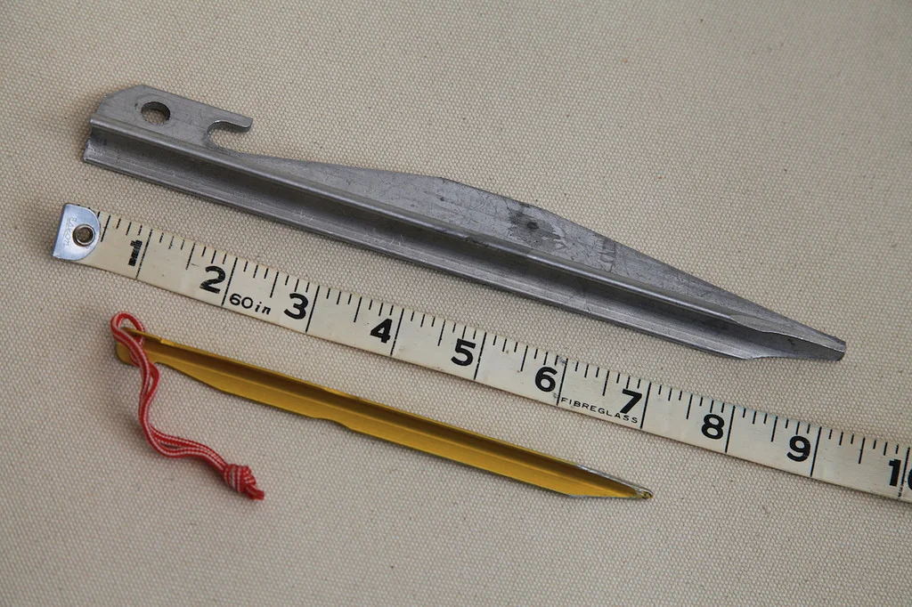 The Ultimate stake on top, with a high-quality but too-small factory stake below