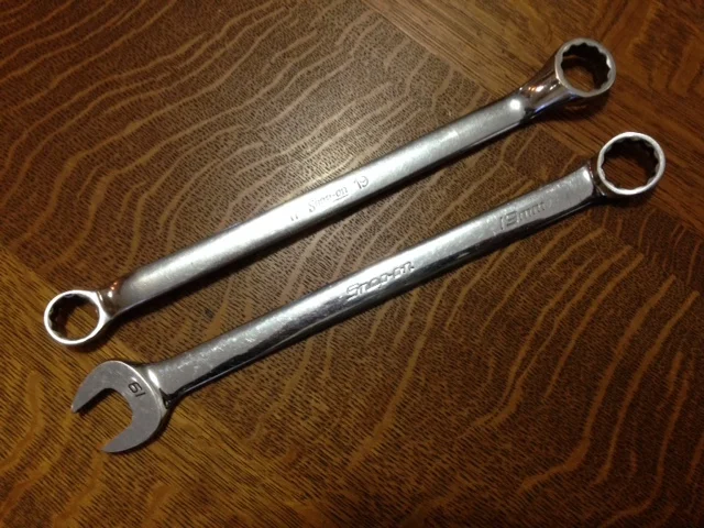 A double box-end wrench (17mm and 19mm) above; a combination wrench (19mm) below.
