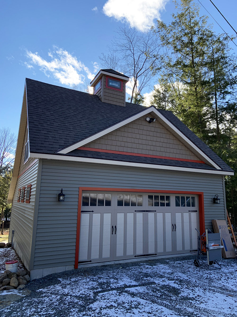 Newly built custom garage with beige siding, built by Steel Pines